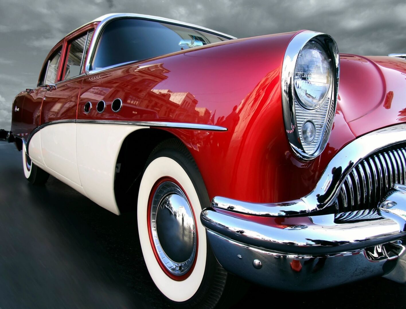 red car and its front tire and headlight