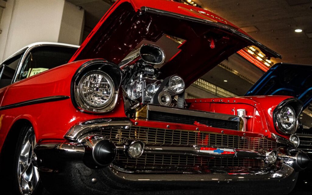 red classic car with the hood open