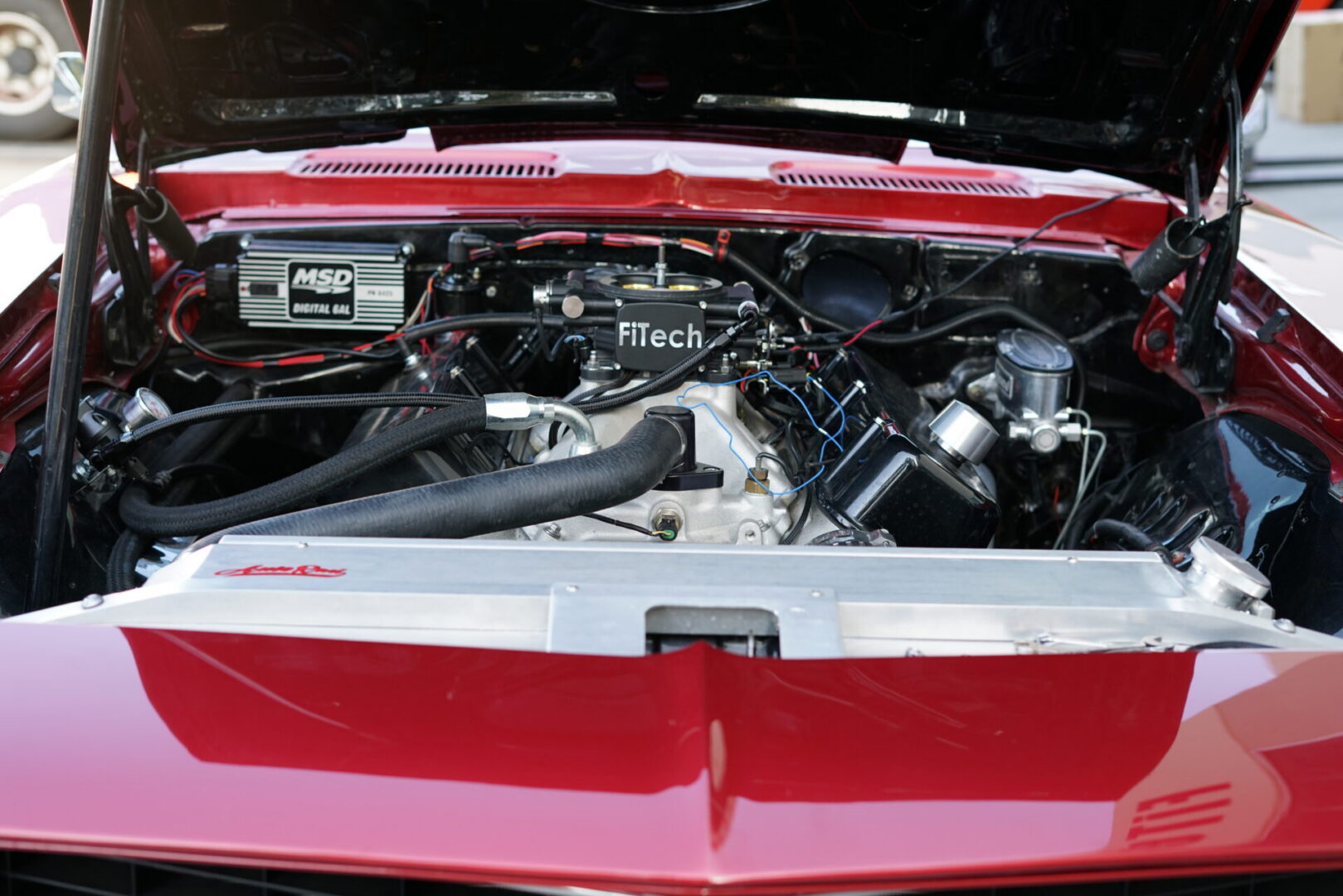 red car with hood open