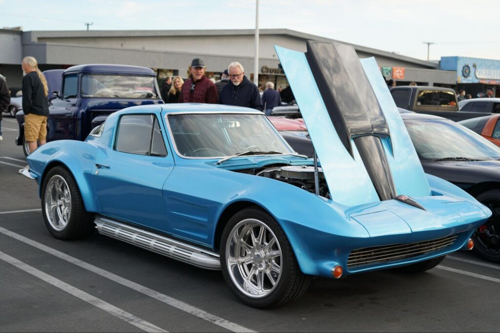 blue classic car with the hood open