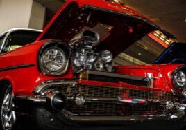 red classic car with the hood open