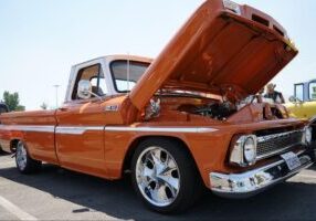 photo of orange classic truck with the hood open