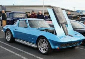 blue classic car with the hood open