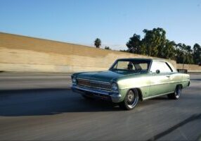 green car driving down the highway